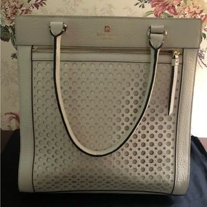 Kate Spade white leather handbag with front zipper pocket.